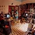 Interior of a bookshop with red shelves full of books, people browsing and working at desks